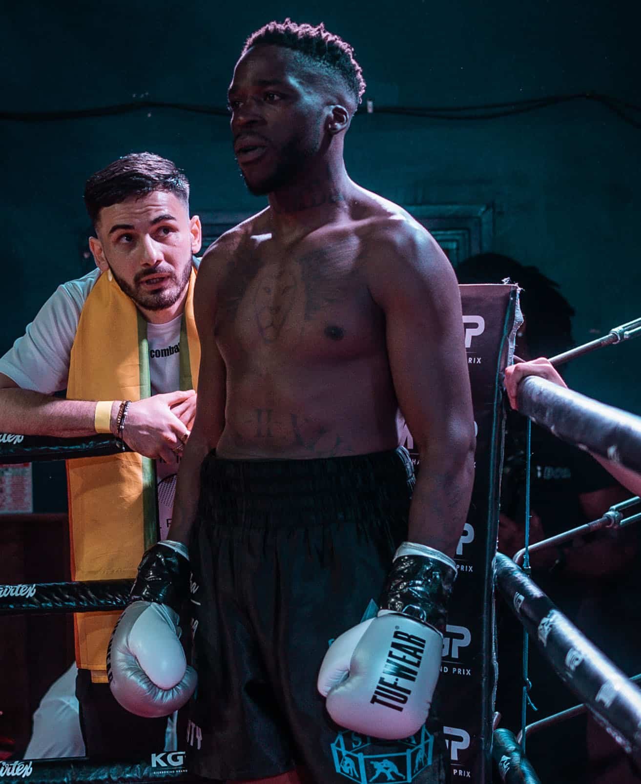 Team Shumba boxer in corner with coach guidance during fight