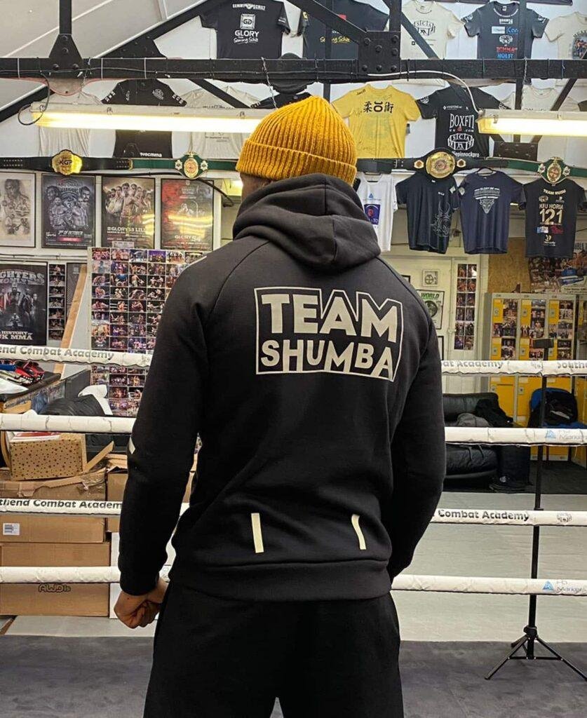 Team Shumba boxing hoodie with sponsor branding, photographed inside the gym ahead of fight night.
